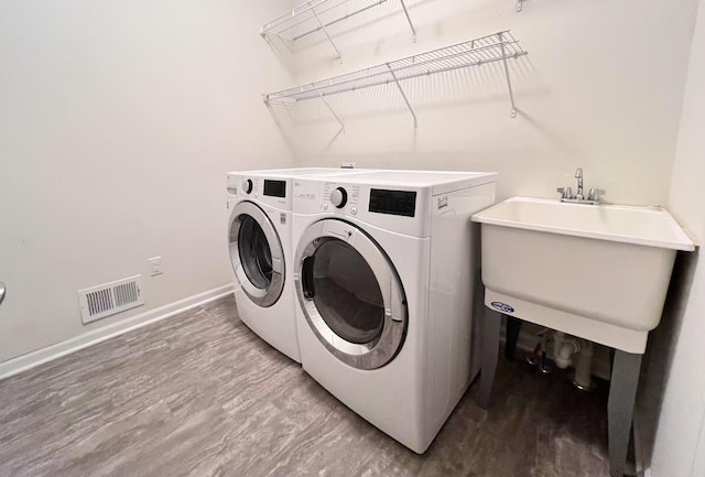 2763 Polson St, Ann Arbor, MI 48105 - clothes washing area featuring washing machine and clothes dryer, baseboards, and wood finished floors