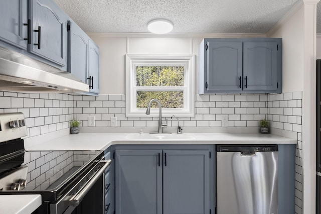 2906 Frankfort Hwy, Frankfort, MI 49635 - kitchen with appliances with stainless steel finishes, a sink, a textured ceiling, light countertops, and tasteful backsplash