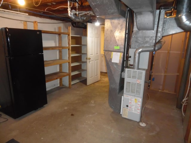 614 Allcott St, Marshall, MI 49068 - unfinished below grade area featuring freestanding refrigerator and heating unit