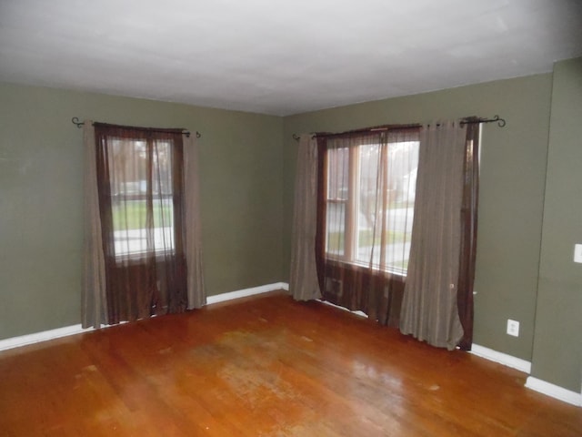 614 Allcott St, Marshall, MI 49068 - spare room with wood finished floors and baseboards