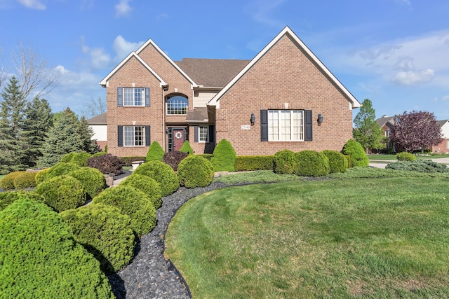 25340 Villagewood, South Lyon, MI 48178 - traditional-style house featuring brick siding and a front lawn