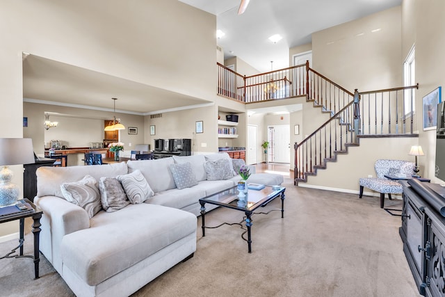 25340 Villagewood, South Lyon, MI 48178 - living area with a towering ceiling, stairway, carpet, a chandelier, and baseboards