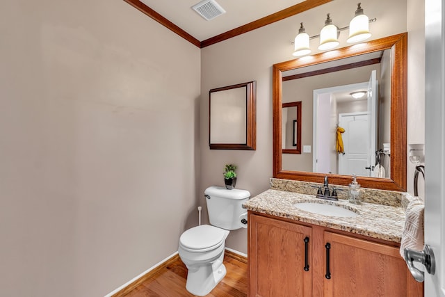25340 Villagewood, South Lyon, MI 48178 - bathroom with ornamental molding, wood finished floors, toilet, vanity, and baseboards