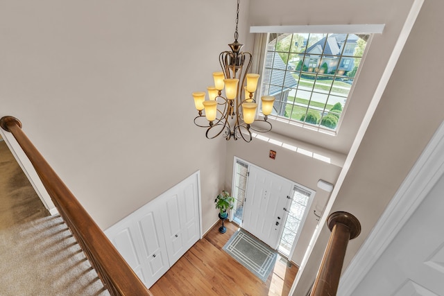 25340 Villagewood, South Lyon, MI 48178 - foyer entrance featuring a chandelier, a towering ceiling, and wood finished floors