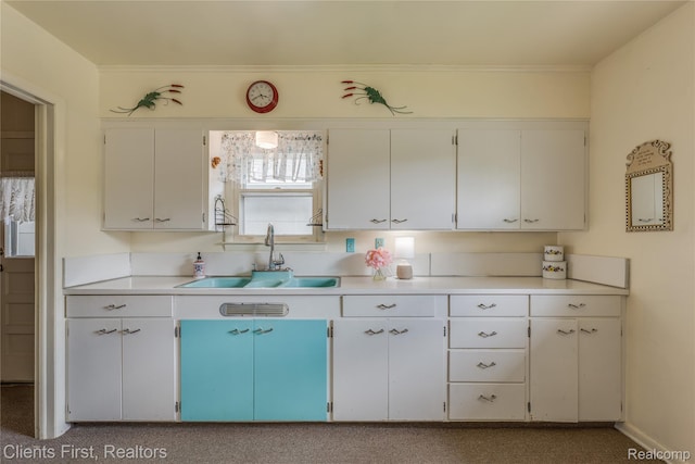 631 Lindsay St, West Branch, MI 48661 - kitchen featuring a sink, light countertops, and white cabinets