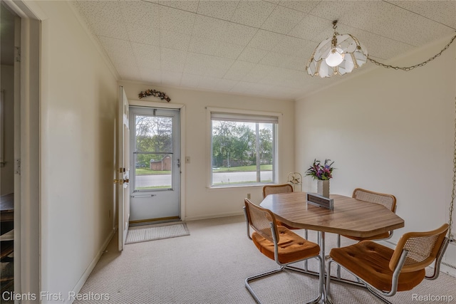 631 Lindsay St, West Branch, MI 48661 - dining area featuring light colored carpet, baseboards, and crown molding