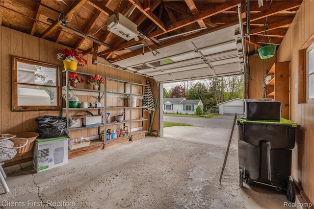 631 Lindsay St, West Branch, MI 48661 - garage with wood walls and a garage door opener