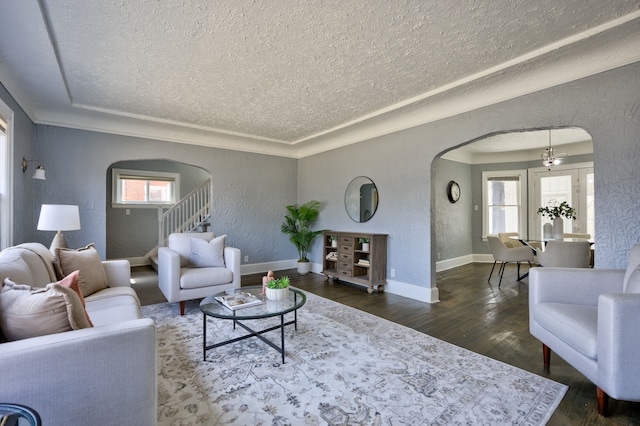 14955 Penrod St, Detroit, MI 48223 - living area with arched walkways, a textured ceiling, healthy amount of natural light, a textured wall, and wood finished floors