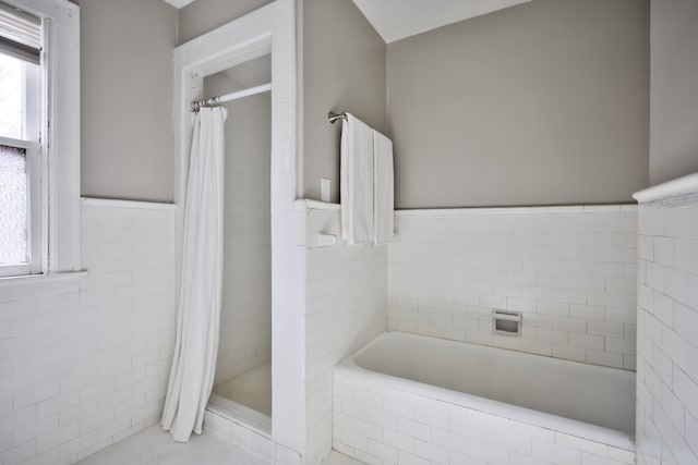 14955 Penrod St, Detroit, MI 48223 - full bathroom featuring a garden tub, a stall shower, a wainscoted wall, and tile walls
