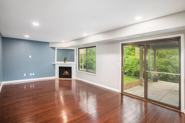 300 Briarcrest Dr Unit 141, Ann Arbor, MI 48104 - unfurnished living room featuring baseboards, wood finished floors, a fireplace with flush hearth, and recessed lighting