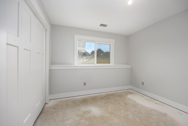 9383 Shimano Dr, Portland, MI 48875 - unfurnished bedroom featuring unfinished concrete floors, baseboards, and a closet