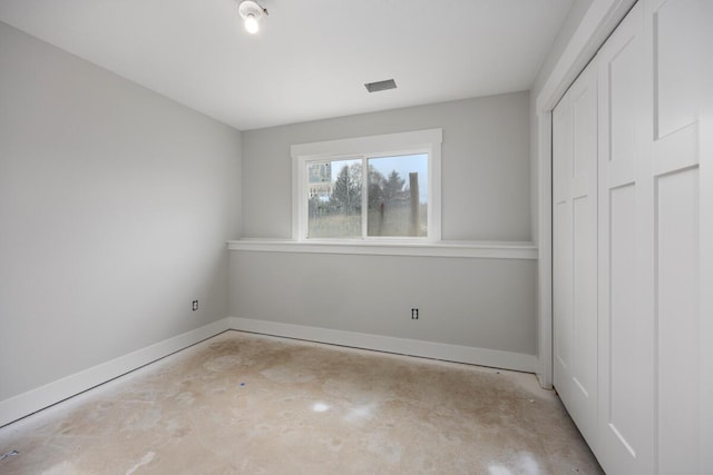 9383 Shimano Dr, Portland, MI 48875 - unfurnished bedroom with concrete flooring, a closet, and baseboards