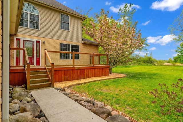 view of green lawn featuring a wooden deck