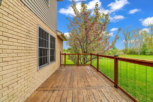 wooden terrace with a lawn