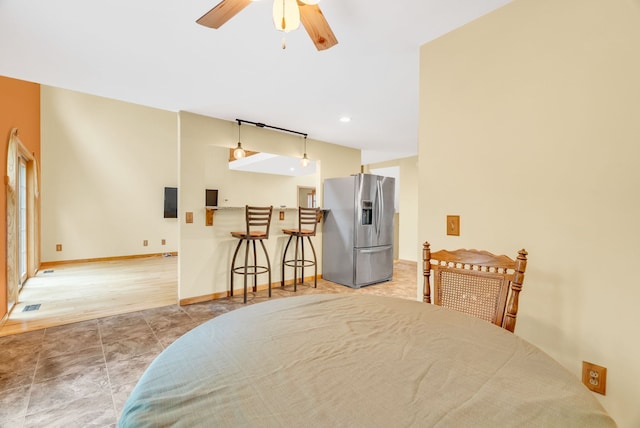 dining room with a bar and a ceiling fan