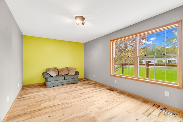 unfurnished room featuring wood finished floors and baseboards