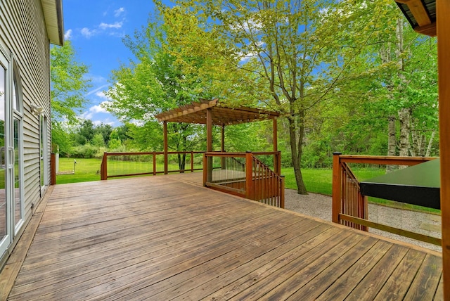 wooden deck with a pergola, a yard, and view of scattered trees