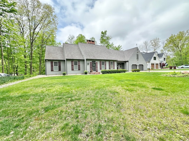 4909 Barnstable Ln, Lansing, MI 48906 - view of front of home featuring a garage, a chimney, a front yard, roof with shingles, and driveway