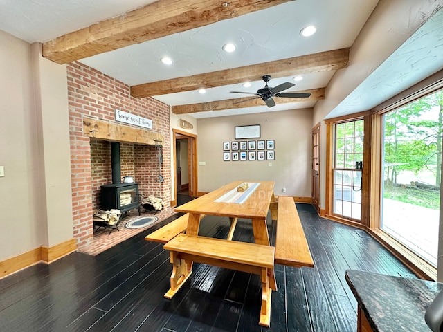 4909 Barnstable Ln, Lansing, MI 48906 - dining room featuring a wood stove, dark wood-type flooring, beam ceiling, recessed lighting, and a ceiling fan