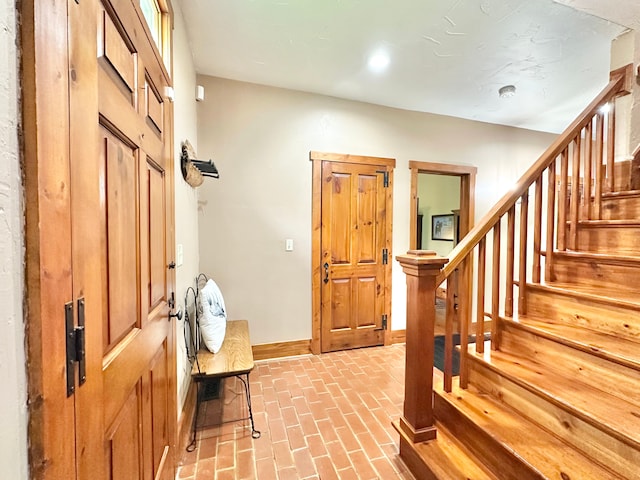 4909 Barnstable Ln, Lansing, MI 48906 - entrance foyer with brick flooring and stairway