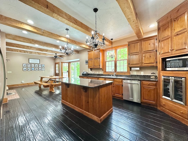 4909 Barnstable Ln, Lansing, MI 48906 - kitchen with stainless steel appliances, a chandelier, beamed ceiling, dark wood-type flooring, and recessed lighting