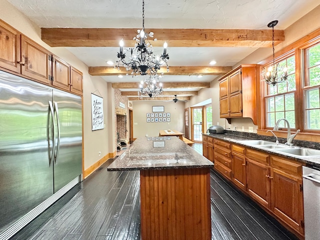 4909 Barnstable Ln, Lansing, MI 48906 - kitchen featuring stainless steel appliances, a chandelier, beamed ceiling, dark wood-type flooring, and a center island