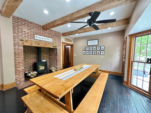 4909 Barnstable Ln, Lansing, MI 48906 - dining area featuring beam ceiling, dark wood finished floors, a wood stove, ceiling fan, and recessed lighting