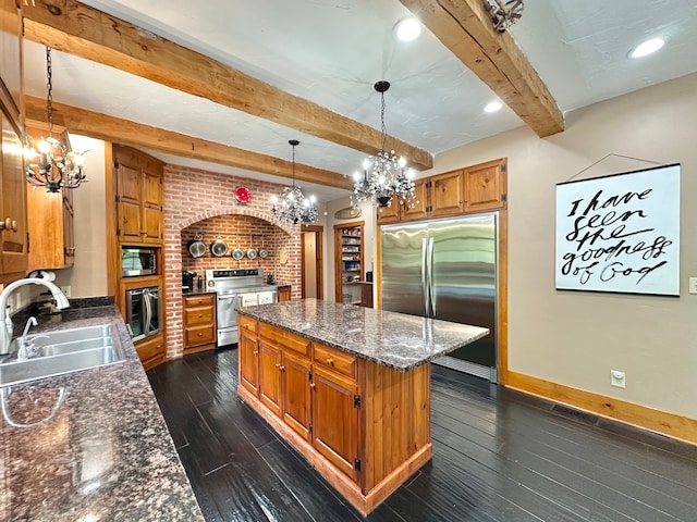 4909 Barnstable Ln, Lansing, MI 48906 - kitchen with built in appliances, a chandelier, beam ceiling, and dark wood finished floors