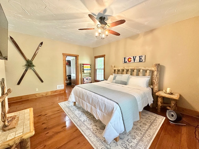 4909 Barnstable Ln, Lansing, MI 48906 - bedroom with wood-type flooring, a ceiling fan, and a spacious closet