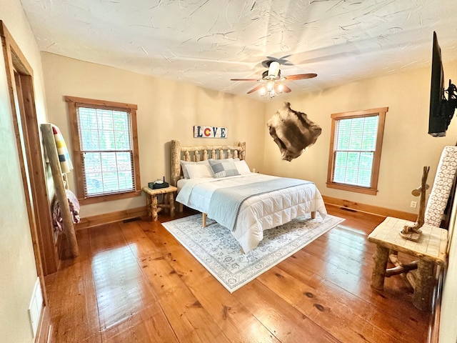 4909 Barnstable Ln, Lansing, MI 48906 - bedroom with hardwood / wood-style floors and a ceiling fan