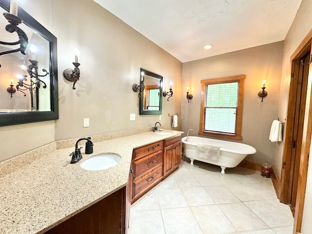 4909 Barnstable Ln, Lansing, MI 48906 - full bath featuring a freestanding tub, double vanity, and tile patterned floors
