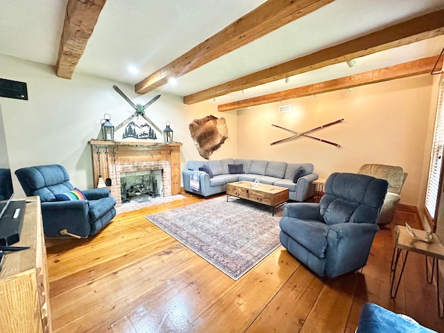 4909 Barnstable Ln, Lansing, MI 48906 - living room with hardwood / wood-style floors, beam ceiling, and a fireplace