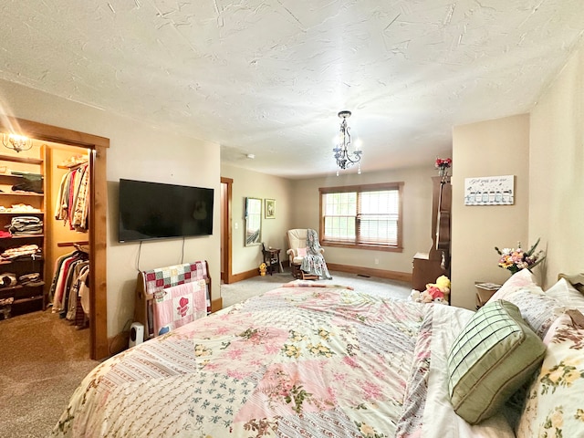 4909 Barnstable Ln, Lansing, MI 48906 - bedroom with carpet flooring, a spacious closet, a closet, and a textured ceiling