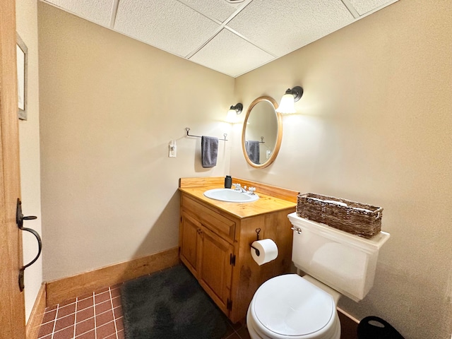 4909 Barnstable Ln, Lansing, MI 48906 - half bath with a drop ceiling, vanity, and tile patterned floors