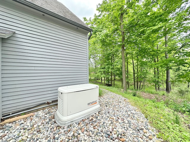 4909 Barnstable Ln, Lansing, MI 48906 - exterior view of a shingled roof, a downspout, and gutters