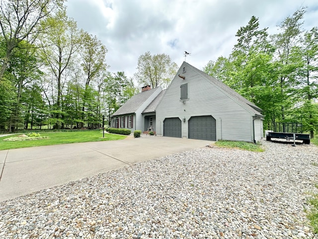 4909 Barnstable Ln, Lansing, MI 48906 - view of side of property with driveway, a chimney, roof with shingles, and view of scattered trees