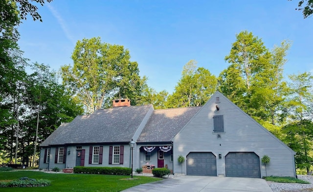 4909 Barnstable Ln, Lansing, MI 48906 - view of front of property with driveway, a front lawn, roof with shingles, a chimney, and an attached garage