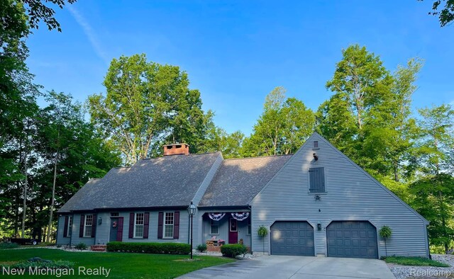 4909 Barnstable Ln, Lansing, MI 48906 - view of front of property with driveway, a front yard, a shingled roof, and a chimney