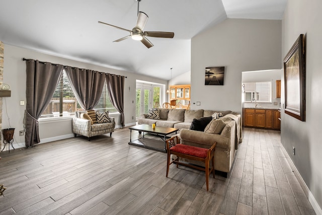 47697 Barclay Ct, Shelby Twp, MI 48317 - living area with ceiling fan, wood finished floors, baseboards, and high vaulted ceiling