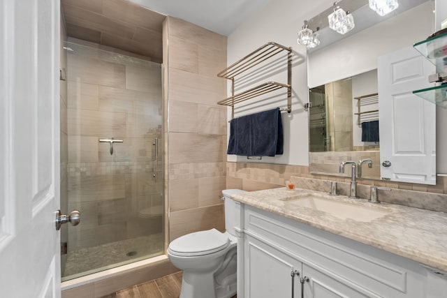47697 Barclay Ct, Shelby Twp, MI 48317 - full bath featuring toilet, a shower stall, tile walls, wood finished floors, and vanity
