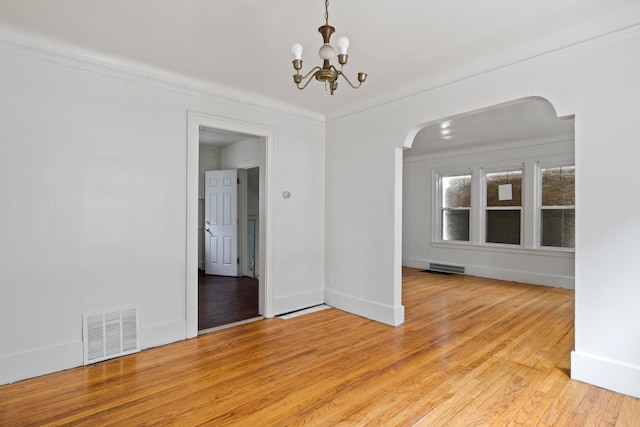 8916 Mendota St, Detroit, MI 48204 - unfurnished dining area featuring arched walkways, light wood-style floors, a chandelier, ornamental molding, and baseboards