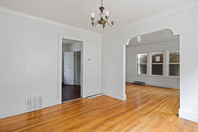 8916 Mendota St, Detroit, MI 48204 - unfurnished dining area with arched walkways, light wood-type flooring, a chandelier, ornamental molding, and baseboards