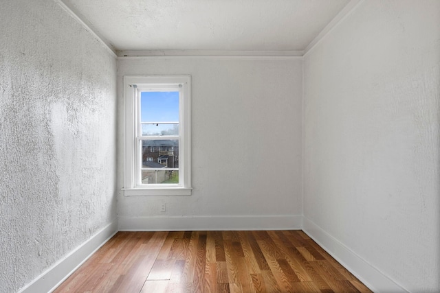 8916 Mendota St, Detroit, MI 48204 - unfurnished room with wood finished floors, baseboards, and ornamental molding