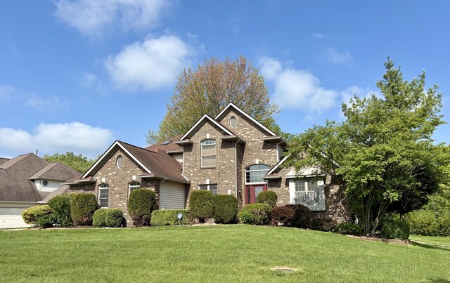 1300 Waterways Dr, Ann Arbor, MI 48108 - traditional-style house featuring brick siding and a front lawn