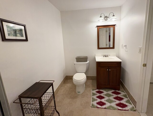 1300 Waterways Dr, Ann Arbor, MI 48108 - bathroom with toilet, tile patterned floors, vanity, and baseboards