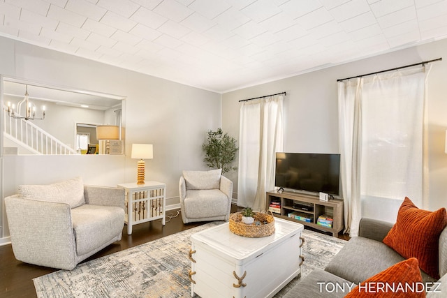 836 Phoenix St, South Haven, MI 49090 - living area with wood finished floors, a chandelier, stairs, crown molding, and baseboards