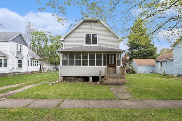 214 S Monroe St, Sturgis, MI 49091 - back of property with a sunroom and a lawn