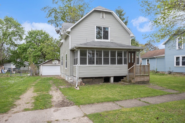 214 S Monroe St, Sturgis, MI 49091 - rear view of property with a sunroom, a garage, an outdoor structure, roof with shingles, and driveway