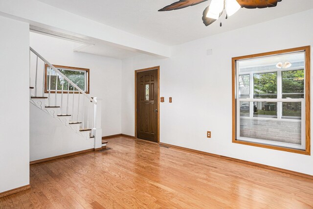 214 S Monroe St, Sturgis, MI 49091 - entrance foyer with light wood-type flooring, stairway, baseboards, and ceiling fan