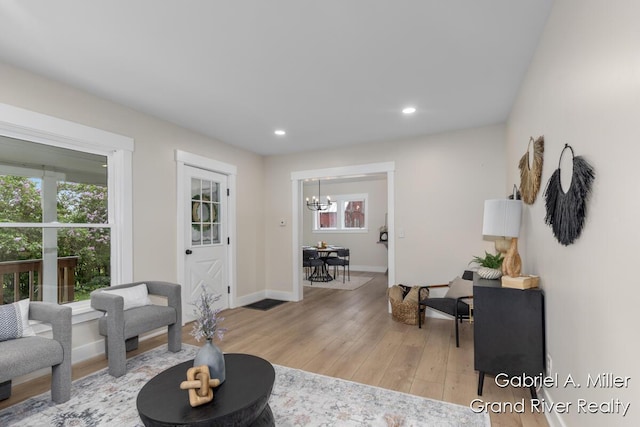 49 E 112th St, Grant, MI 49327 - living area featuring a chandelier, plenty of natural light, light wood finished floors, recessed lighting, and baseboards